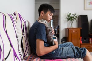 Shao Jian Feng, 26, holds a Yangtze alligator (Alligator sinensis) in his home on the outskirts of Beijing