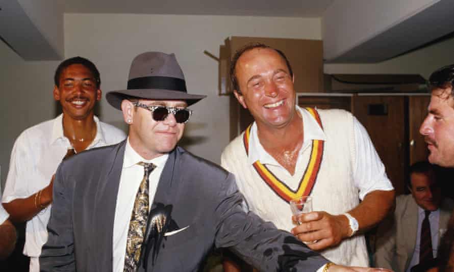 Allan Lamb (right edge of shot) shares a joke – and champagne – with singer Elton John after England beat Australia in the fourth Ashes Test in Melbourne in 1986.
