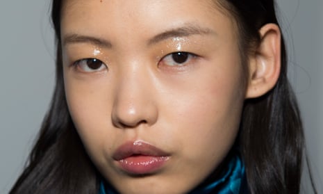 A model's face with eye and lip gloss