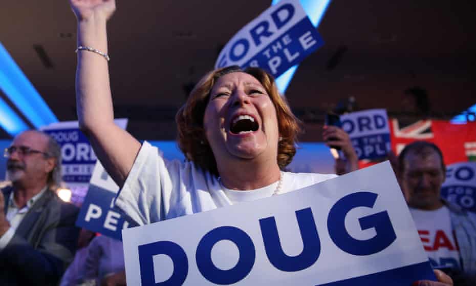 A Doug Ford supporter celebrates the Ontario election results giving a majority to his Progressive Conservative party.