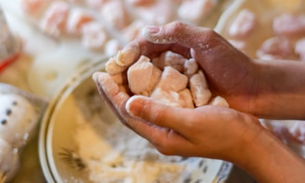 Flouring homemade chicken nuggets.