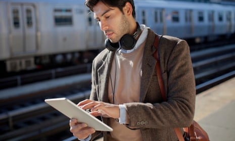 Man using tablet computer at station