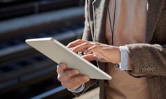 Man using tablet computer at station