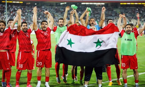 Syria’s players celebrate after their 2-2 draw in Iran secured in the final minute which secured them a play-off place against Australia.