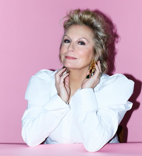 Jennifer Saunders wears white shirt with puffed sleeves, painted nails and jewellery
