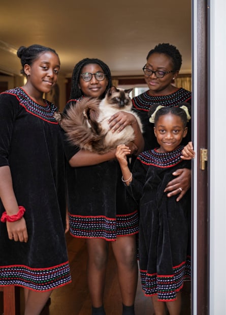 Ndah Tatani Mbawa, her three daughters and their cat, Zaki.