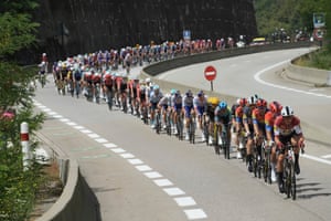 Tour de France cyclists cycle in a big line up a hill