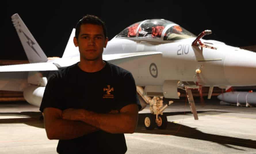 Michael Raymond stands in front of an air force plane