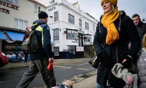 Passersby outside Whitby's Magpie cafe