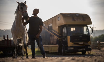 Faisal Qadir at the Batley Hall Farm Riding Centre with a white horse