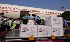 Workers unloading a delivery of a Covid-19 coronavirus vaccine from India to Myanmar, at Yangon International Airport in Yangon.