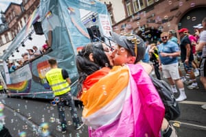 Two people kiss draped in fabric
