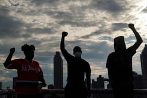 People raise their fists during an event to mark Juneteenth, which commemorates the end of slavery in Texas, two years after the 1863 Emancipation Proclamation freed slaves elsewhere in the United States, amid nationwide protests against racial inequality, in Atlanta, Georgia, U.S. June 19, 2020.