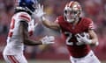 San Francisco 49ers running back Christian McCaffrey, right, stiff-arms New York Giants cornerback Adoree' Jackson during the second half of Thursday’s game.