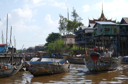 A boat chugs through Kampong Phluk commune, close to Tonlé Sap lake in Cambodia