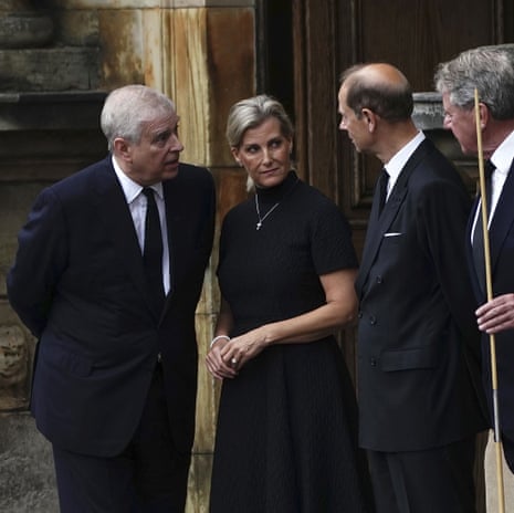 Britain's Prince Andrew, left, Sophie, Countess of Wessex, and Prince Edward await the arrival of the hearse.