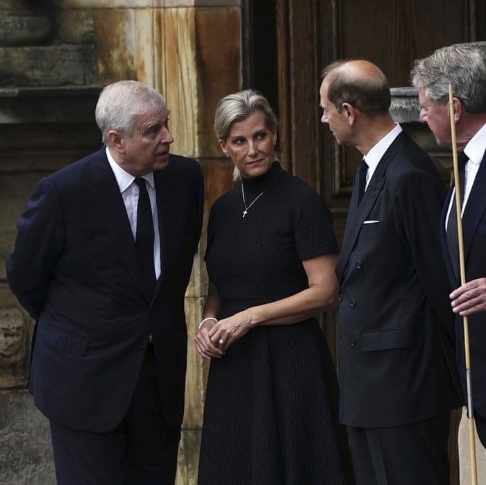 Britain's Prince Andrew (left), Sophie, Countess of Wessex, and Prince Edward await the arrival of a hearse.