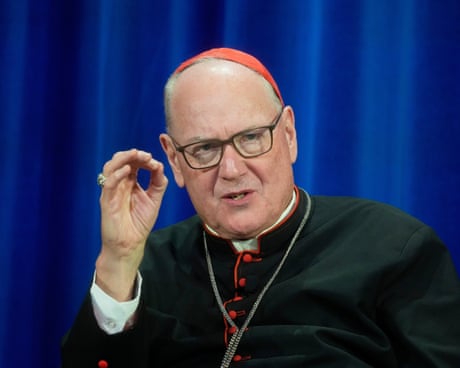 a man in a religious vestments speaks with hand gestured