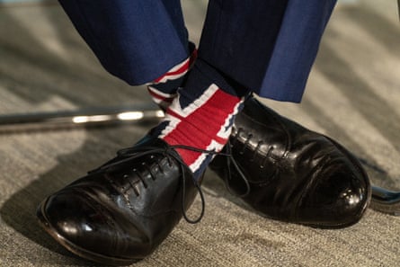 Farage’s feet. He is wearing union flag socks and black leather shoes