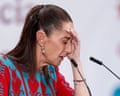 Mexican president Claudia Sheinbaum puts her hand to her face during a news conference in Mexico City