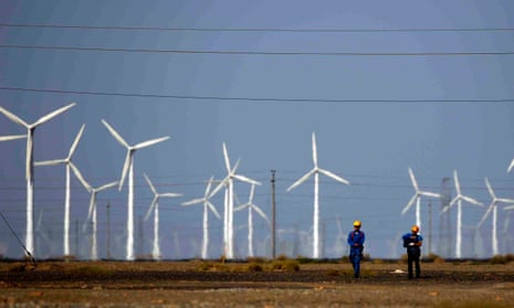 Workers at a wind farm in Guazhou, China. The country’s emissions have fallen as renewable energy has increased and coal use has fallen.