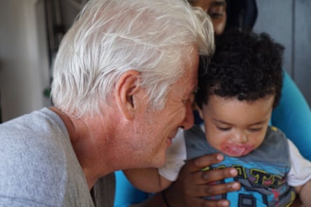 Richard Gere is seen with a young child on the Open Arms vessel