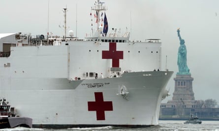 The USNS Comfort medical ship moves up the Hudson river, past the Statue of Liberty as it arrives in New York City in March.