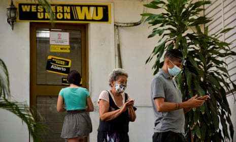 Cubans queue outside a Western Union office in Havana this week. More than 400 Western Union offices in Cuba will close their doors due to new sanctions imposed by the US.
