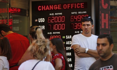 People line up at a currency exchange shop in Istanbul. Investors have been pulling out of Turkey’s markets, sending its stock market and currency plunging.