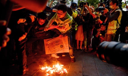 Taiwanese protesters burn a Chinese national flag.