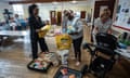 Volunteers gather food into bags