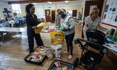 Volunteers gather food into bags