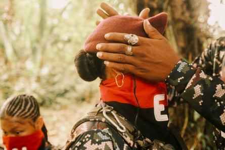 An ELN member adjusts another’s beret