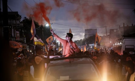 Madagascan president Andry Rajoelina rides in a pickup truck as he greets supporters during his re-election campaign, in Toamasina, in November 2023.