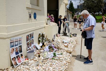 A man stands by the piles of memorial stones in memory of the 15 victims of the Bondi beach shooting on 14 December.