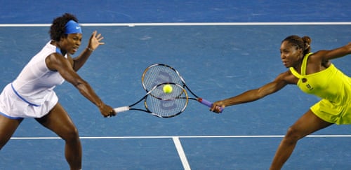 Serena Williams (left) and her sister Venus attempt to return the same ball 
