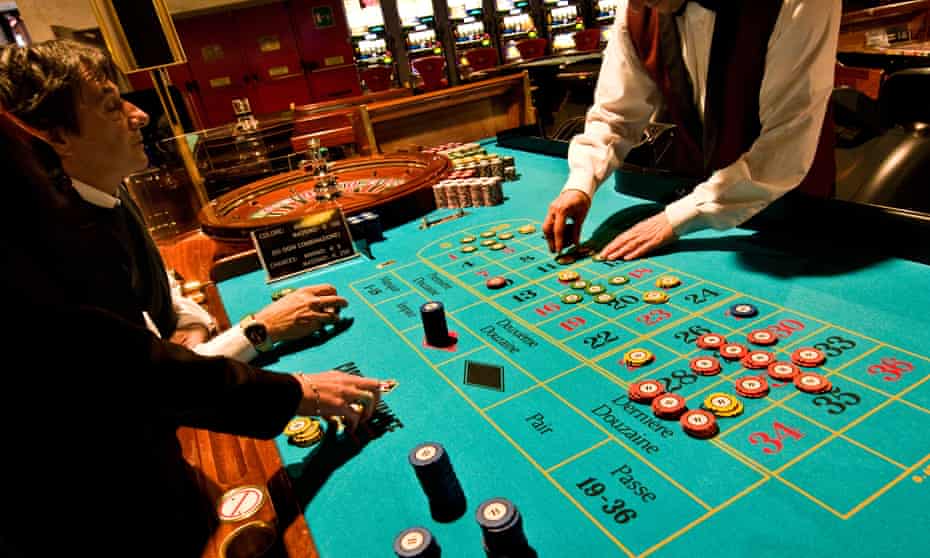 People gambling at roulette table in an Italian casino.