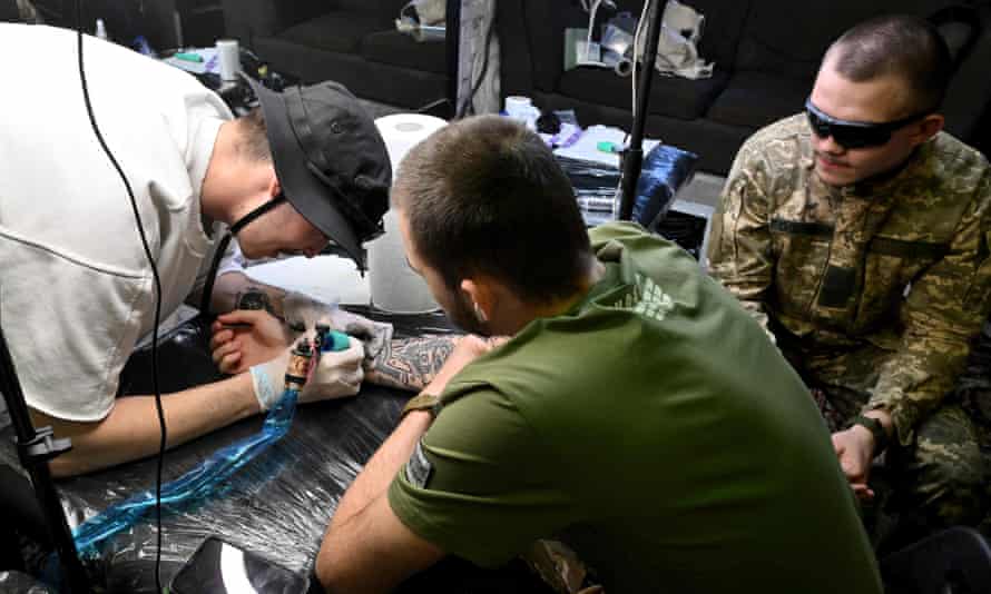 Ukrainian servicemen get tattoos during the Art Weapon festival in Kyiv.