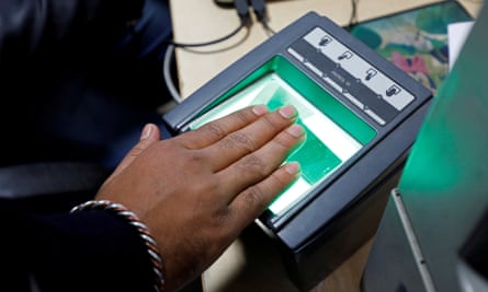 A woman scanning her fingerprints for use in India’s Aadhaar biometric ID scheme.