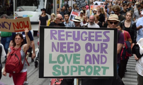 Protests supporting refugees in Australia holding a banner with the words - refugees need our love and support