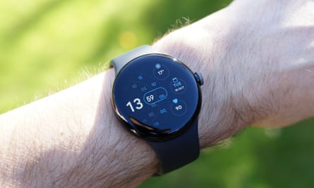 The Pixel Watch showing the face on a male wrist.