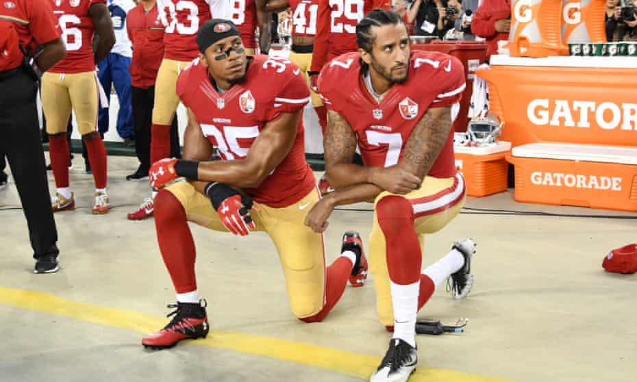 Colin Kaepernick and Eric Reid kneel in protest during the US national anthem in 2016.