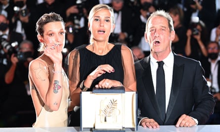 Ducournau with Titane stars Agathe Rousselle and Vincent Lindon after winning the Palme d’Or at Cannes, July 2021.