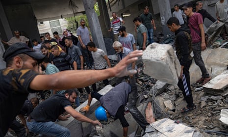 Palestinians look for survivors in a building destroyed during Israeli bombardment in Rafah refugee camp in Gaza Strip on Tuesday, 17 October 2023.