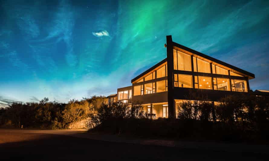 The northern lights flicker above Hotel Husafell, Iceland.