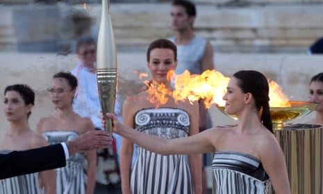 Actor Mary Mina, playing an ancient Greek high priestess, holds the Olympic torch at a ceremony in Athens before it began its sea journey to France.
