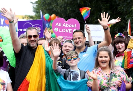 Leo Varadkar at a Pride march, surrounded with people smiling and holding LGBTQ+ flags