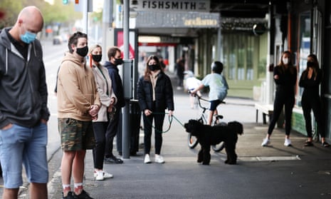 People wait for takeaway coffee outside an eatery in Herne Bay in Auckland, New Zealand