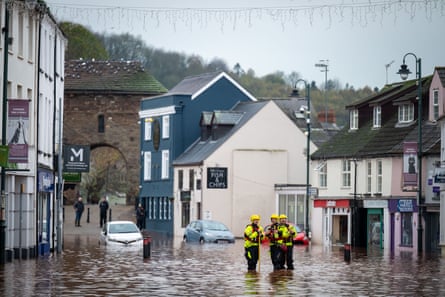 Firefighters at work in a flooded street