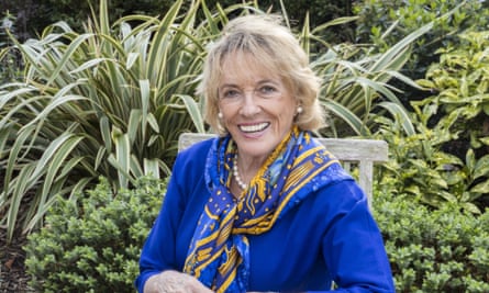 Esther Rantzen in blue dress surrounded by plants